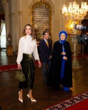 الملكة رانيا العبدالله تنسّق المعطف الصوفي المنحوت ببراعة مع بلوزة بيضاء بياقة عالية