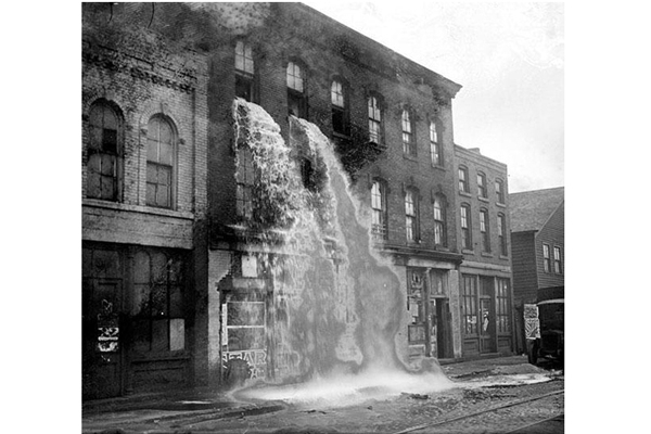 37-Illegal alcohol being poured out during Prohibition Detroit 1929