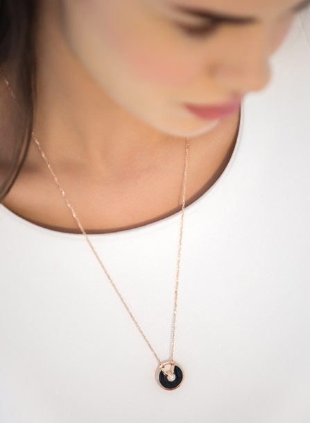 تألقي بقلادة أموليت دو كارتييه بحجم صغير من الذهب الوردي والأونيكس والماس مع سلسلة من الذهب الوردي.