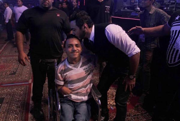 	تامر يلتقط صورة تذكارية مع شاب معوّق