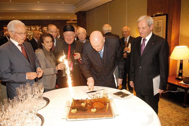 الشيخ ميشال الخوري يقطع قالب حلوى وبدا من اليمين: الوزير فوزي صلوخ، المطران بولس مطر، السيدة دونيز جبارة خوري، الأميرال سمير الخادم، الدكتور شفيق محرم